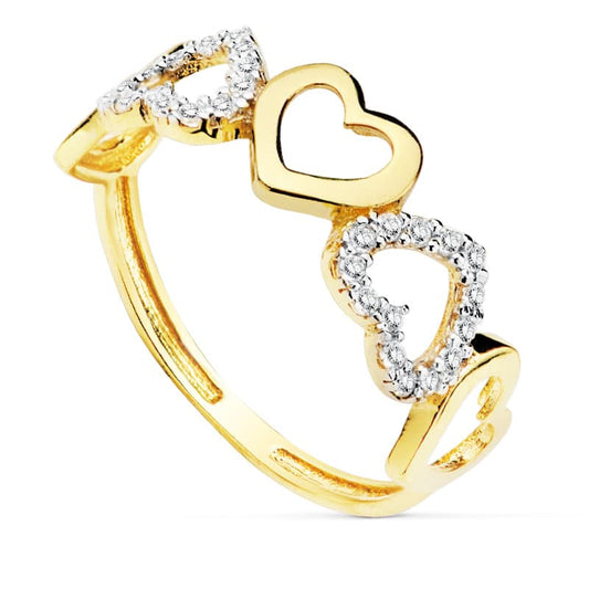Sortija de oro bicolor 18K con cinco corazones lisos y con circonitas.